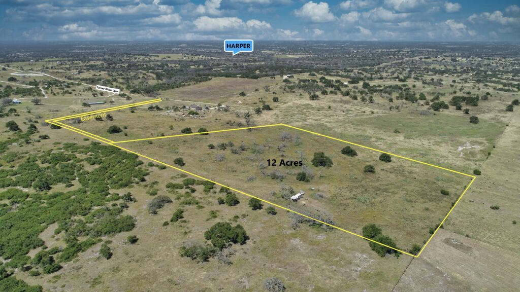 Drone view of rolling terrain and land boundaries at 2112 Turkey Ridge Lane, Harper, TX