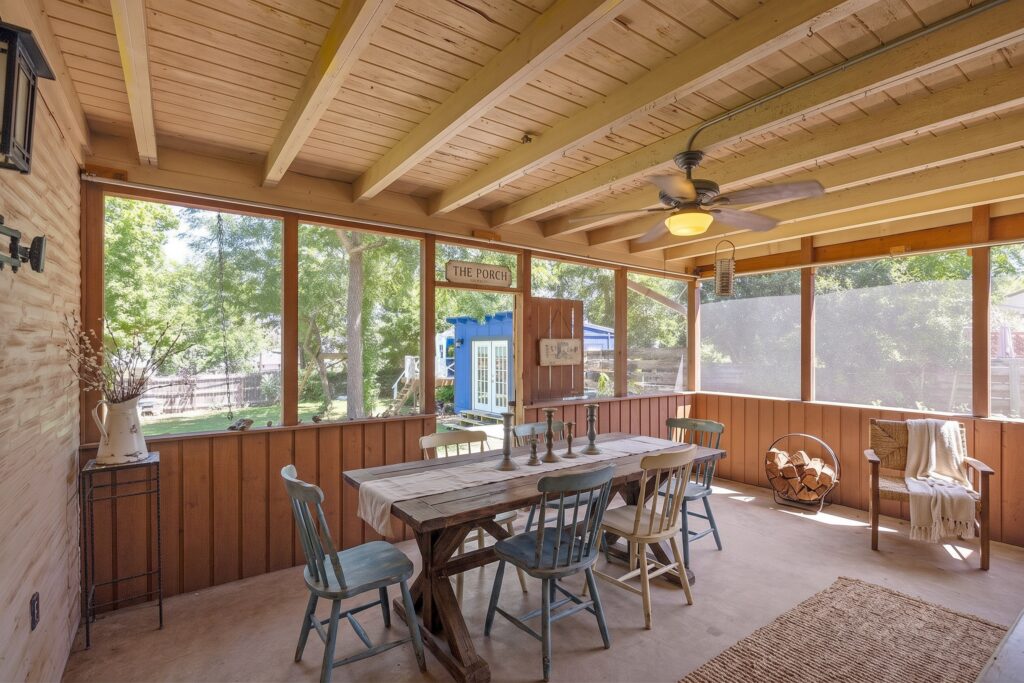 Virtually staged screened porch with dining table at 705 Overhill Drive