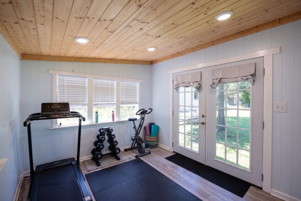 Virtually staged she-shed set up as a home gym at 705 Overhill Drive