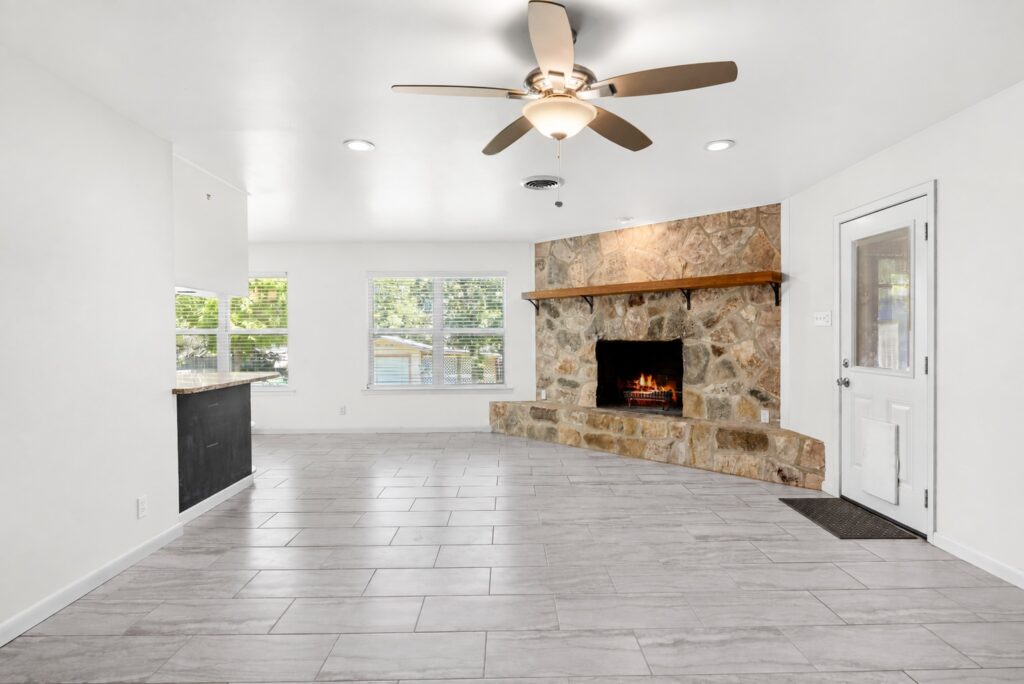 Living room with floor-to-ceiling stone fireplace at 705 Overhill Drive