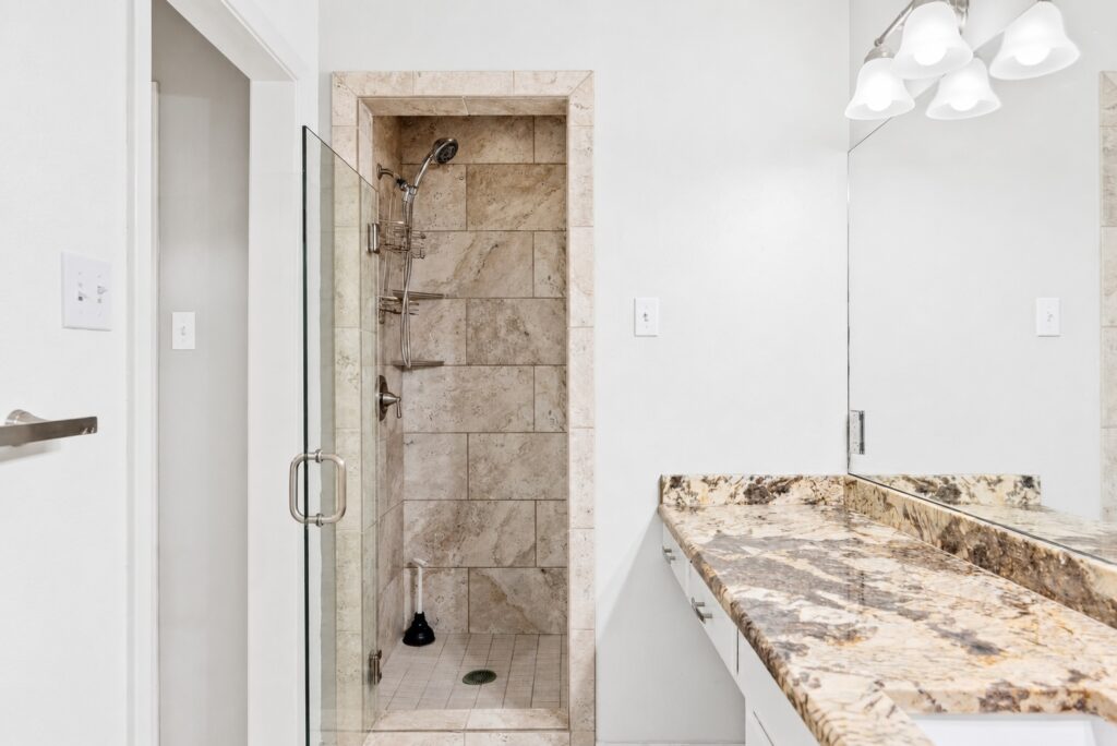 Primary bathroom with walk-in tile shower