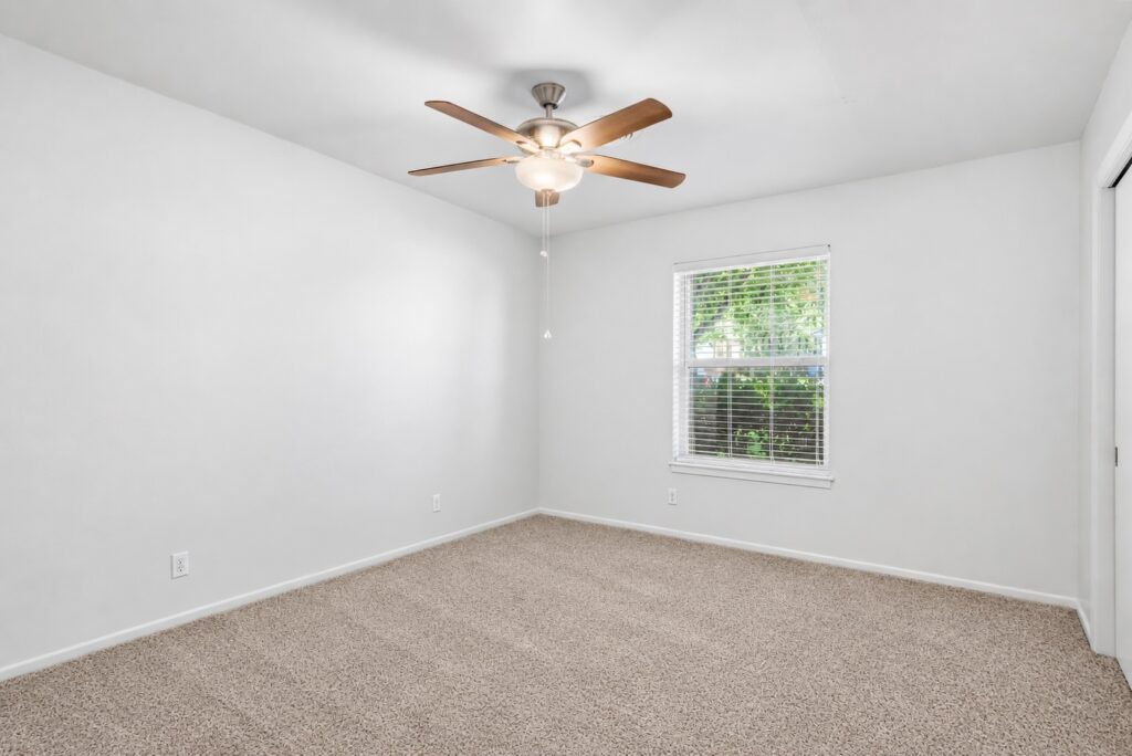 Second bedroom with fresh white paint and natural light