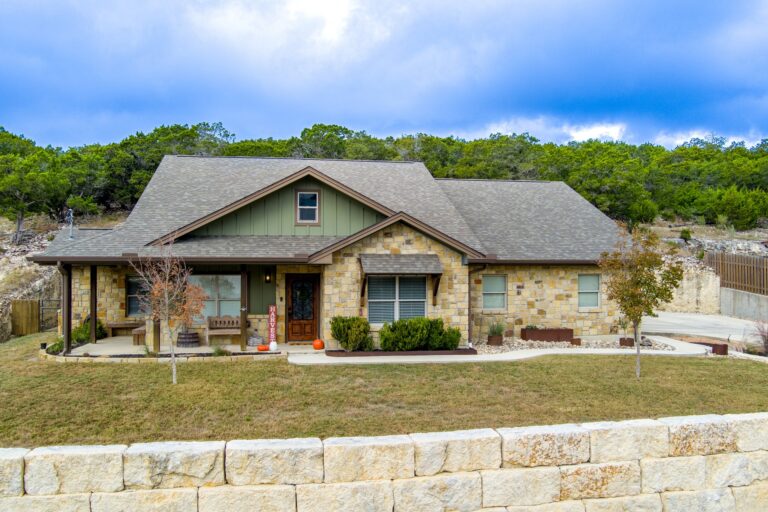 Front exterior of 119 Fannin Drive, Kerrville, a native limestone and board-and-batten home on 1.16 acres in Northwest Hills