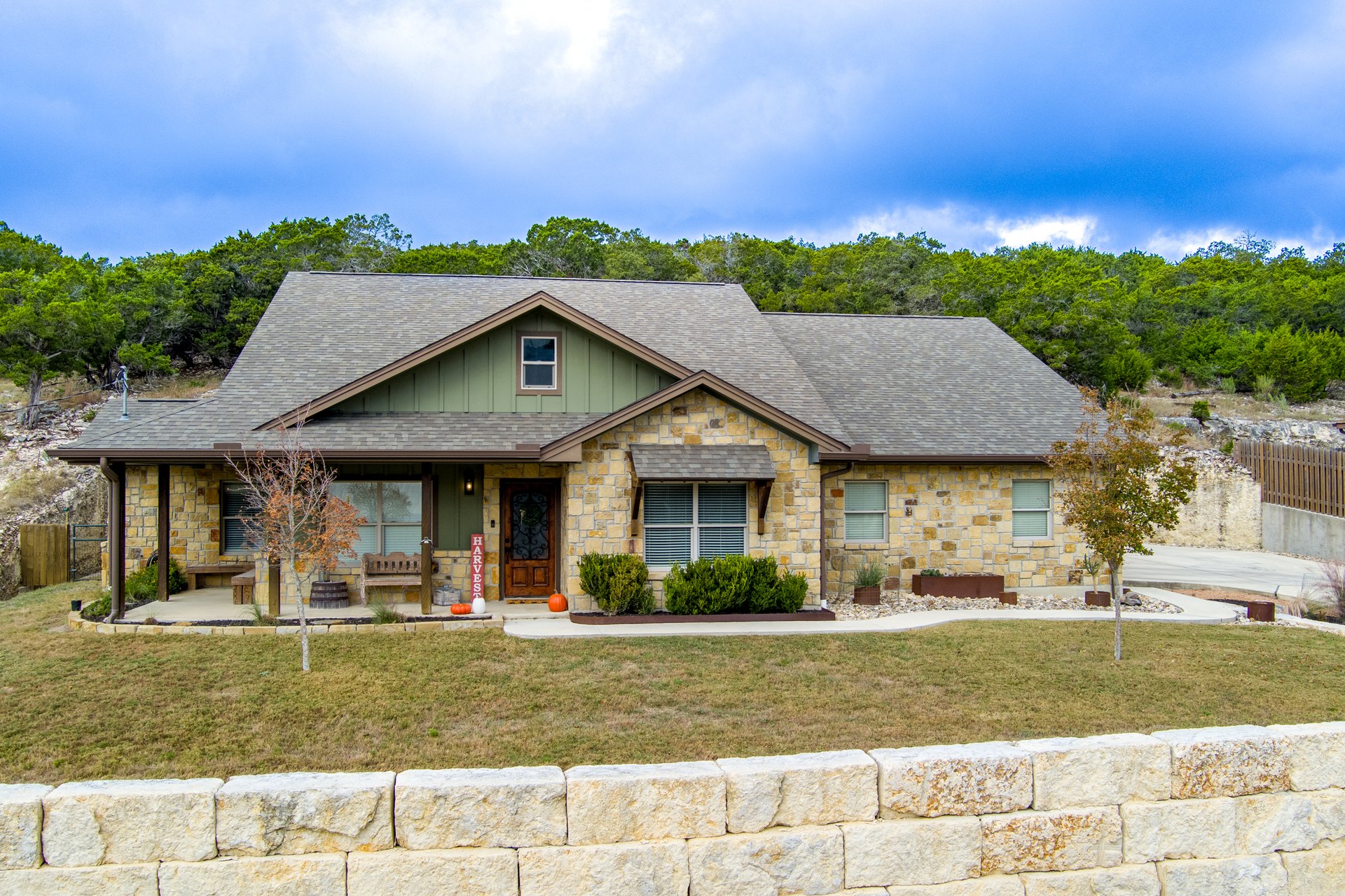 Front exterior of 119 Fannin Drive, Kerrville, a native limestone and board-and-batten home on 1.16 acres in Northwest Hills