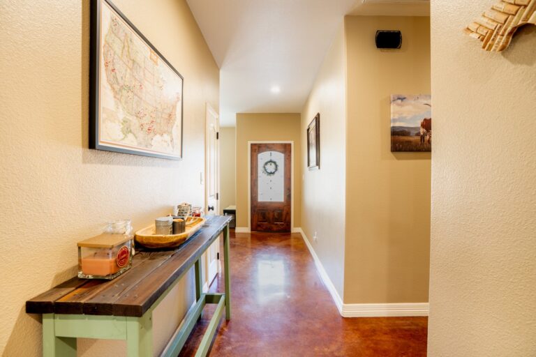 Entry hall at 119 Fannin Drive, Kerrville with stained concrete floors running to the front door