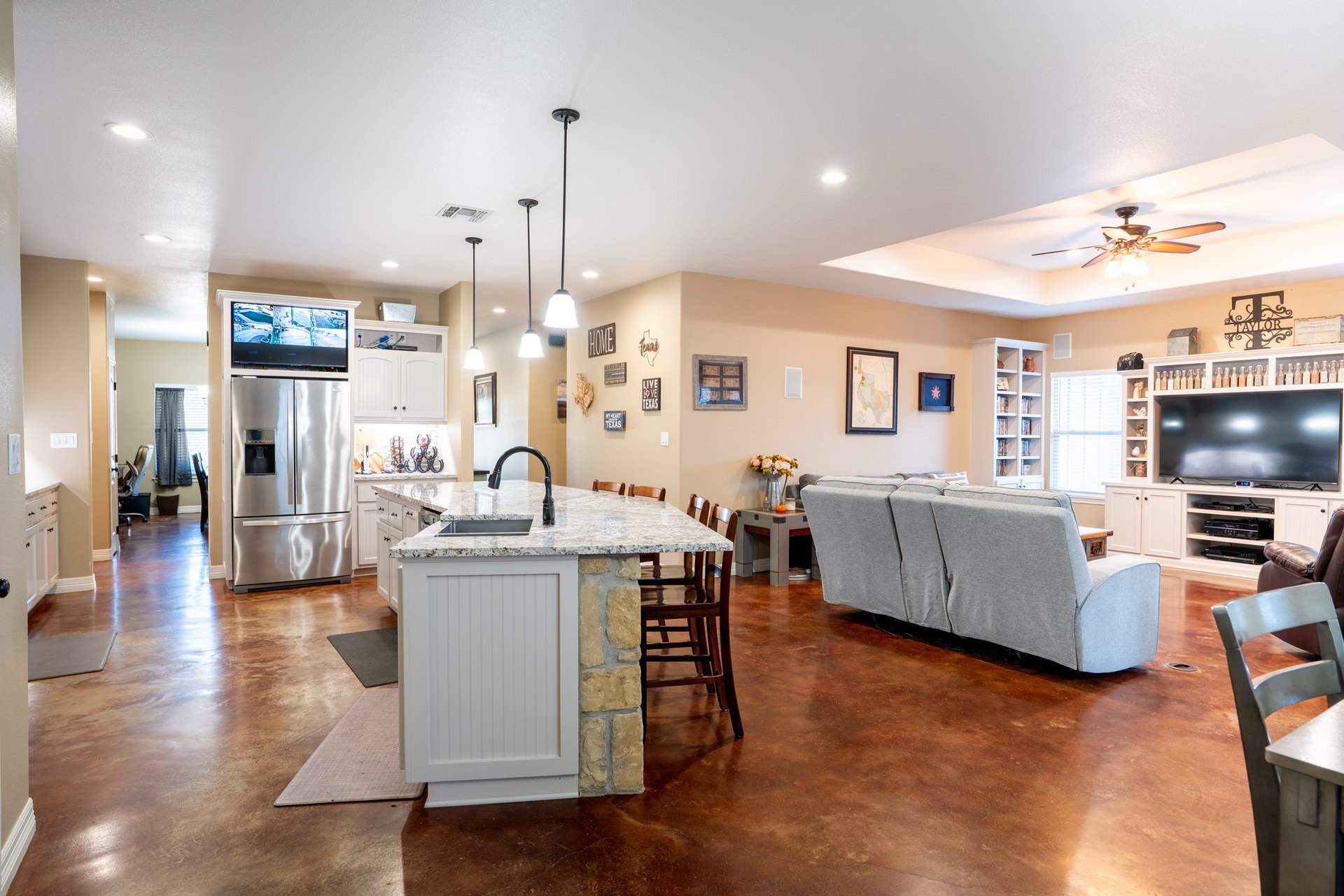 Open kitchen, breakfast and living area with stained concrete floors at 119 Fannin Drive, Kerrville