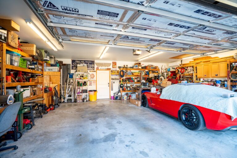 Heated and cooled two-car garage with insulated door, built-in shelving and workbench at 119 Fannin Drive, Kerrville